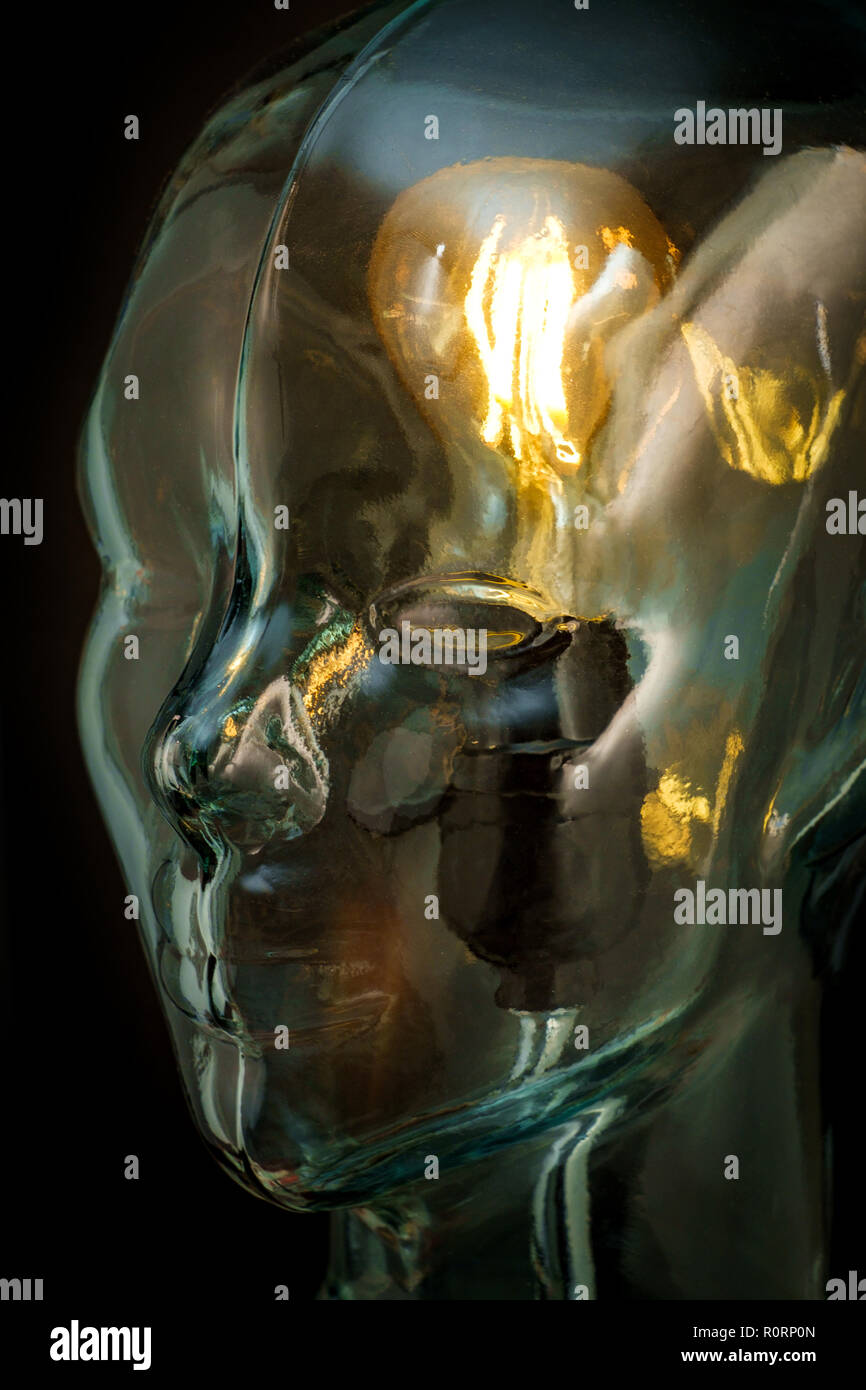 Bright lightbulb inside glass head for creative thoughts and ideas concept Stock Photo