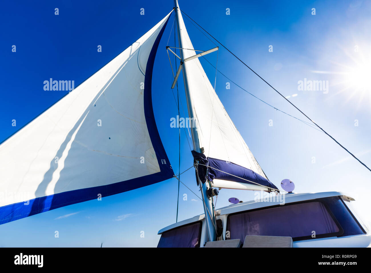 White sails of a sailing yacht in the wind. Recreational water sport Stock Photo