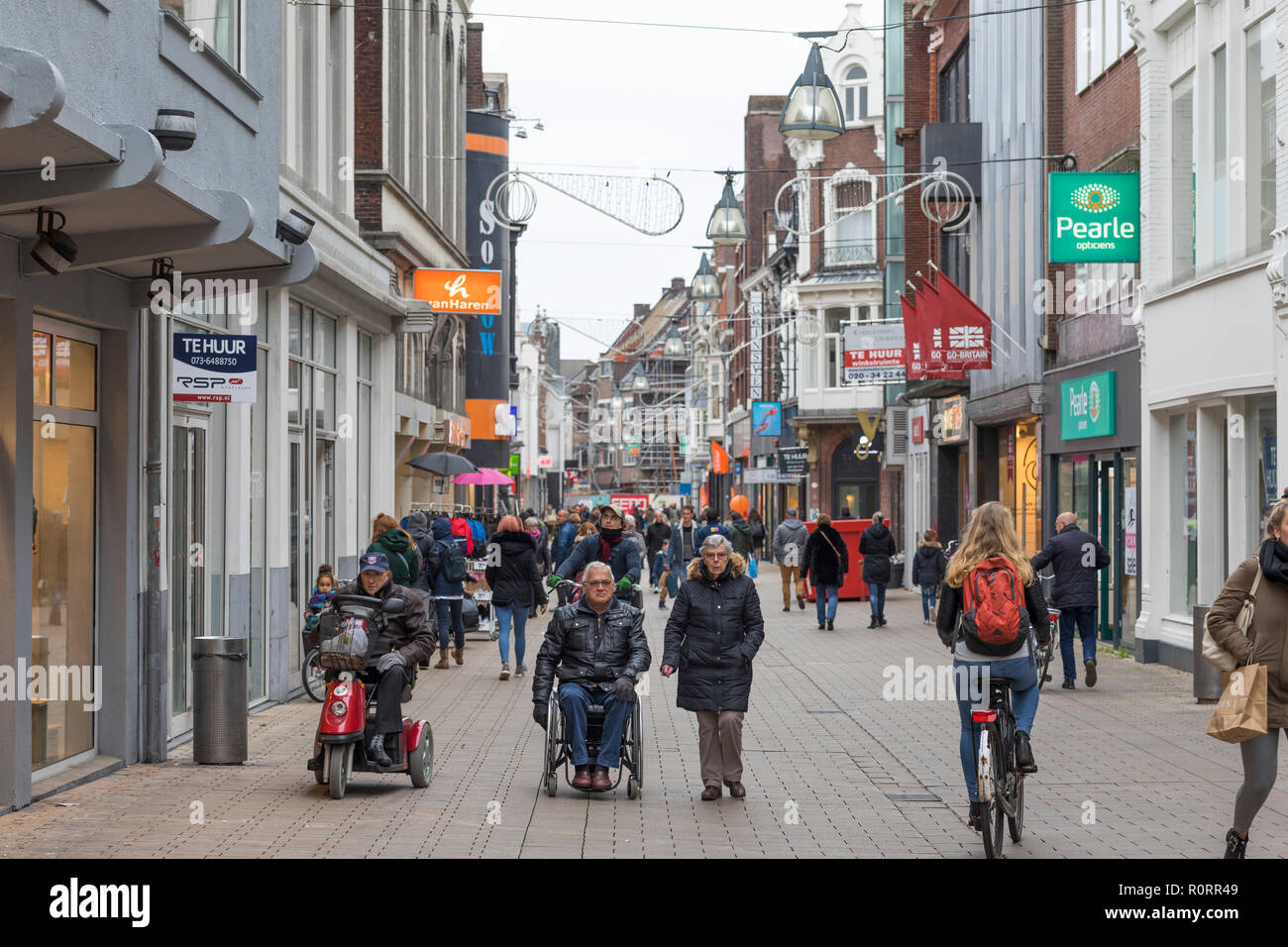 People shopping in pedestrian zone in the inner city of Tilburg with retail shops, Neterlandfs Stock Photo