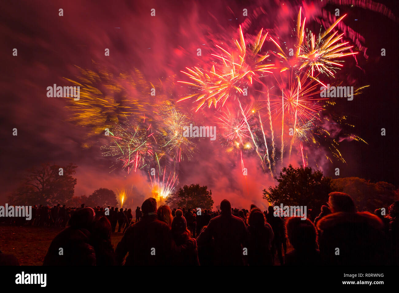 People watching a fireworks display at Helvingham Hall, Suffolk, UK. Stock Photo