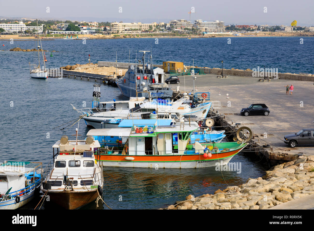 Paphos harbour, Cyprus October 2018. Local traditional fishing boats share the quay with the police coastguard boat. Stock Photo