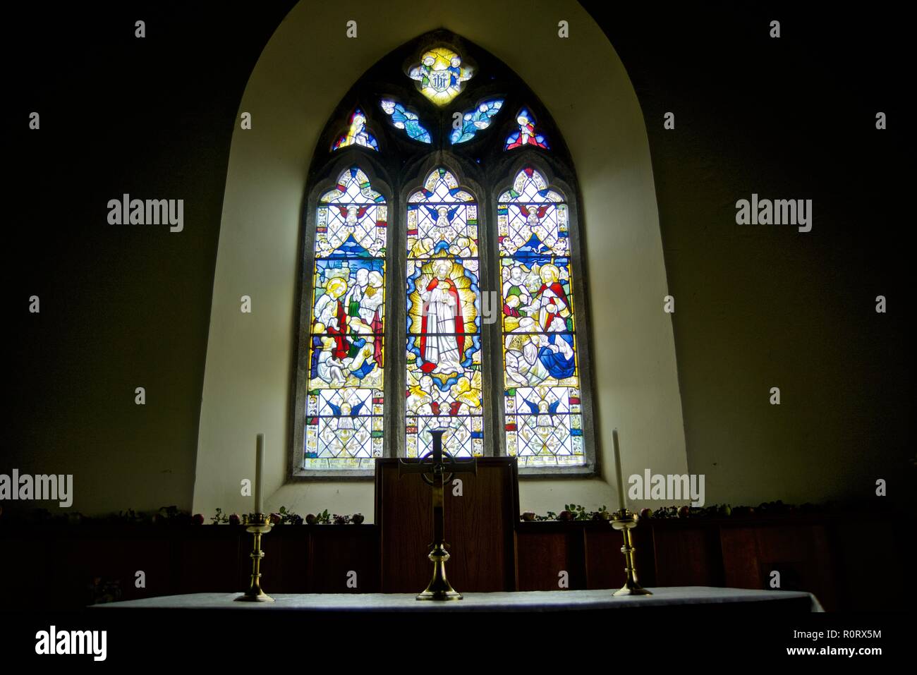 Stained Glass Windows, interior view St Seiriol's Church, Penmon, Anglesey, North Wales, UK Stock Photo