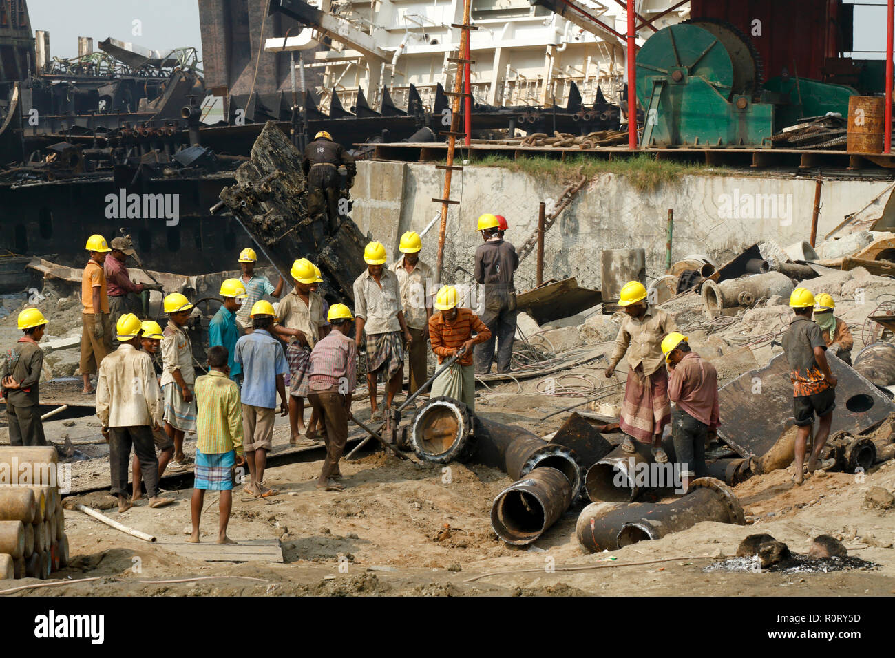 Labourers  work at ship- breaking yard. Bangladesh is dependent on ship-breaking industry for 80% of its steel needs. Chittagong, Bangladesh. Stock Photo