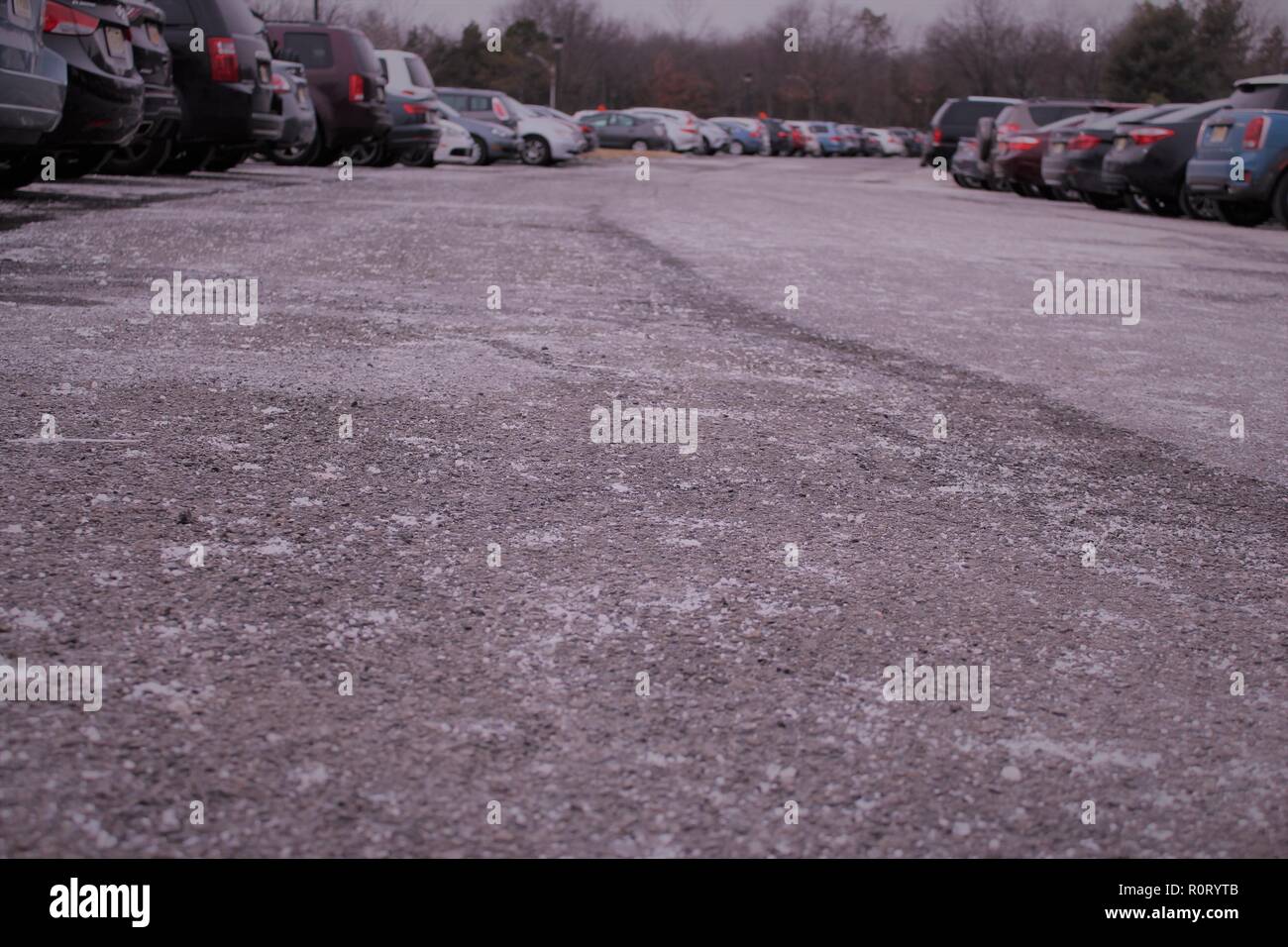 Salt covering the icy parking lot full of cars Stock Photo Alamy