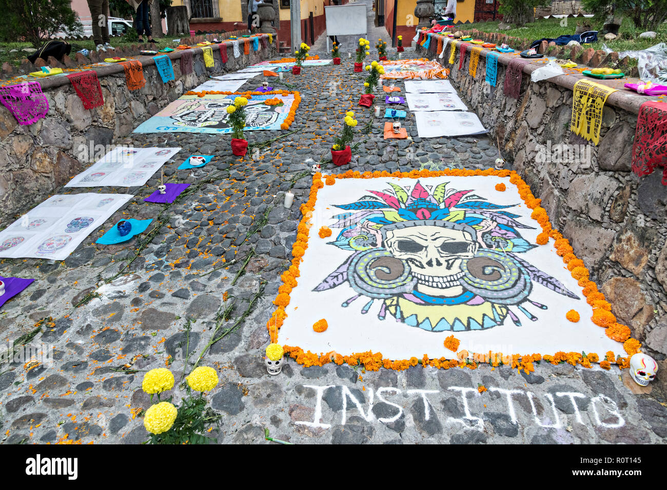 Dead of the Dead sand paintings on display outside the San Juan de Dios Church during the Dia de Muertos festival in San Miguel de Allende, Mexico. The multi-day festival is to remember friends and family members who have died using calaveras, aztec marigolds, alfeniques, papel picado and the favorite foods and beverages of the departed. Stock Photo