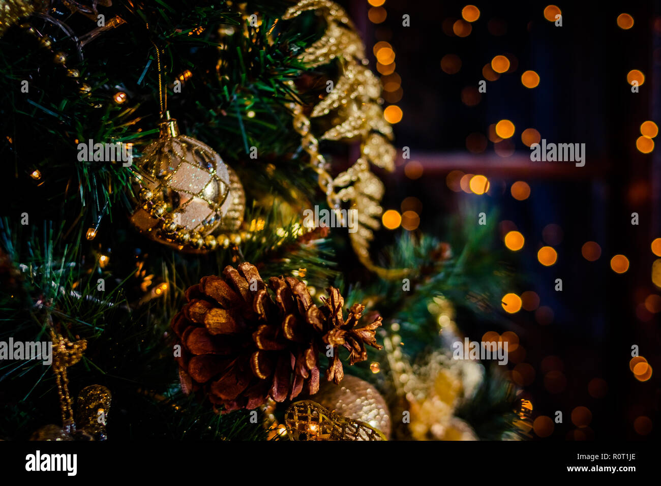 Fir branch with balls and festive lights on the Christmas background ...