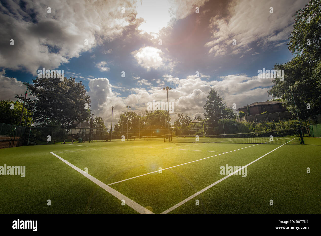An all weather tennis court at the local park on a beautiful summers