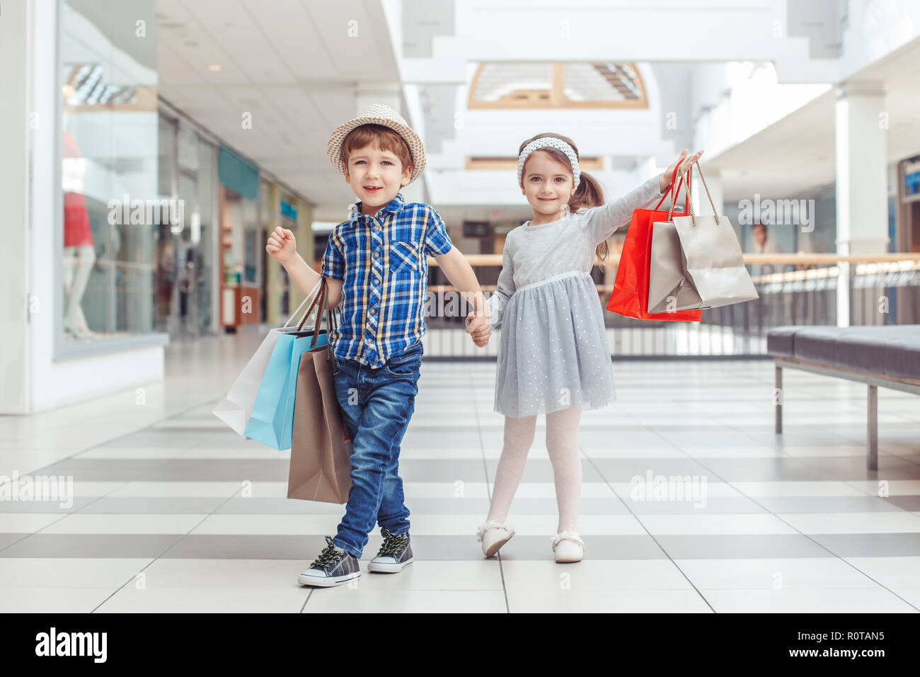 Group portrait of two cute adorable preschool children going shopping. Caucasian little girl and