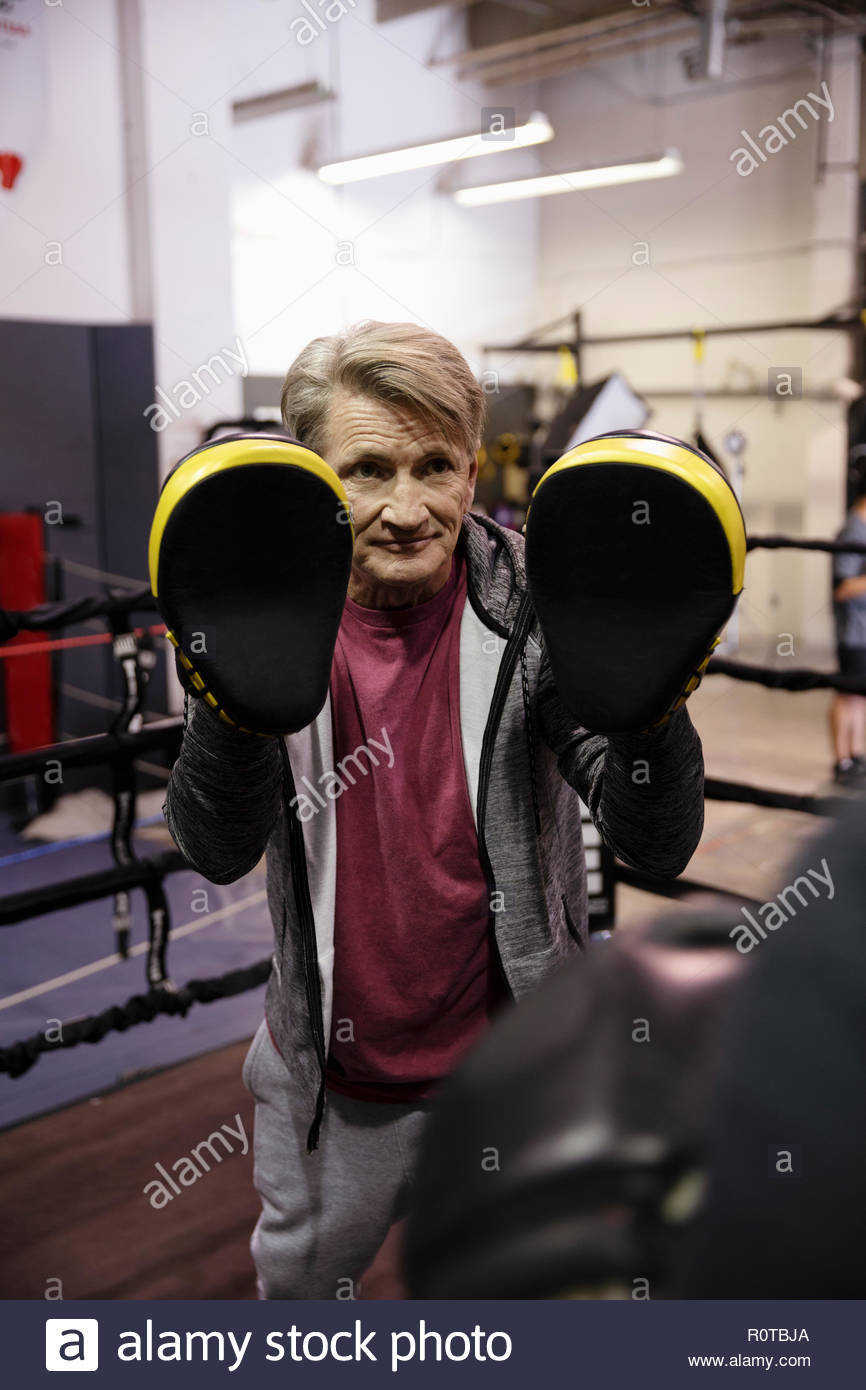 Male trainer with boxing pads in gym Stock Photo Alamy