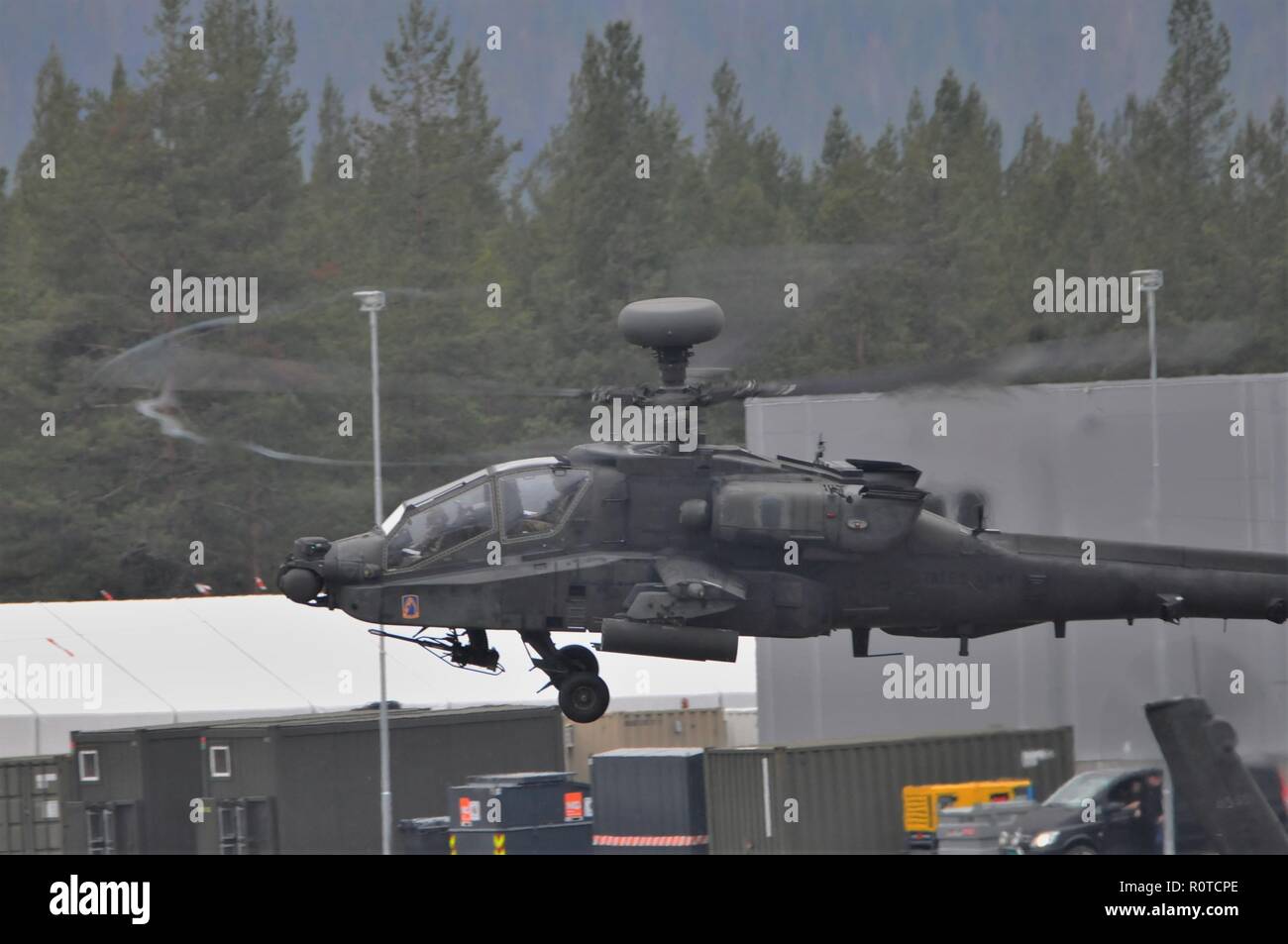 A U.S. Army Apache helicopter assigned to the 1st Battalion, 3rd Aviation Regiment, 12th Combat Aviation Brigade departs Rena Leir Airfield, Norway, during Trident Juncture 18, Nov. 5, 2018. Trident Juncture is a NATO-led military exercise held in Norway. The exercise is the largest of its kind in Norway since the 1980s. An expected 51,000 participants from over 30 nations will take part, including 10,000 vehicles, 150 aircraft and 60 vessels. The main goals of Trident Juncture is to train the NATO Response Force and to test the alliance's defense capabilities. (U.S. Army photo by Charles Rose Stock Photo