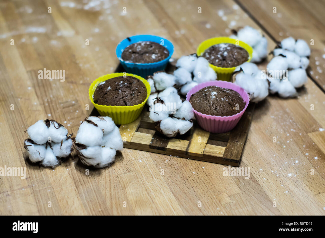 Chokolate cupcakes with powder on the wooden table with cotton Stock Photo
