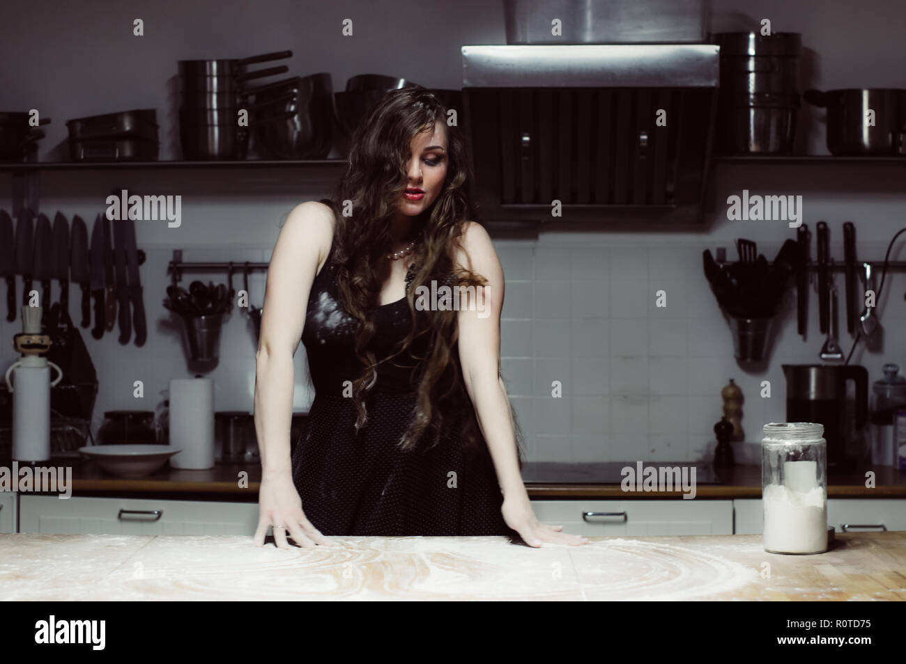 Beautiful hostess cooking, flour on the table Stock Photo