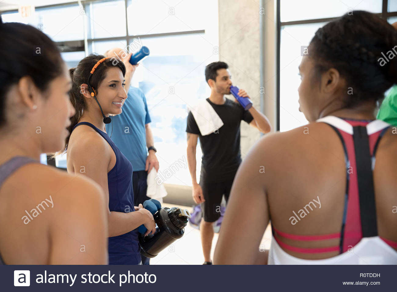 Women talking after group exercise class in gym Stock Photo
