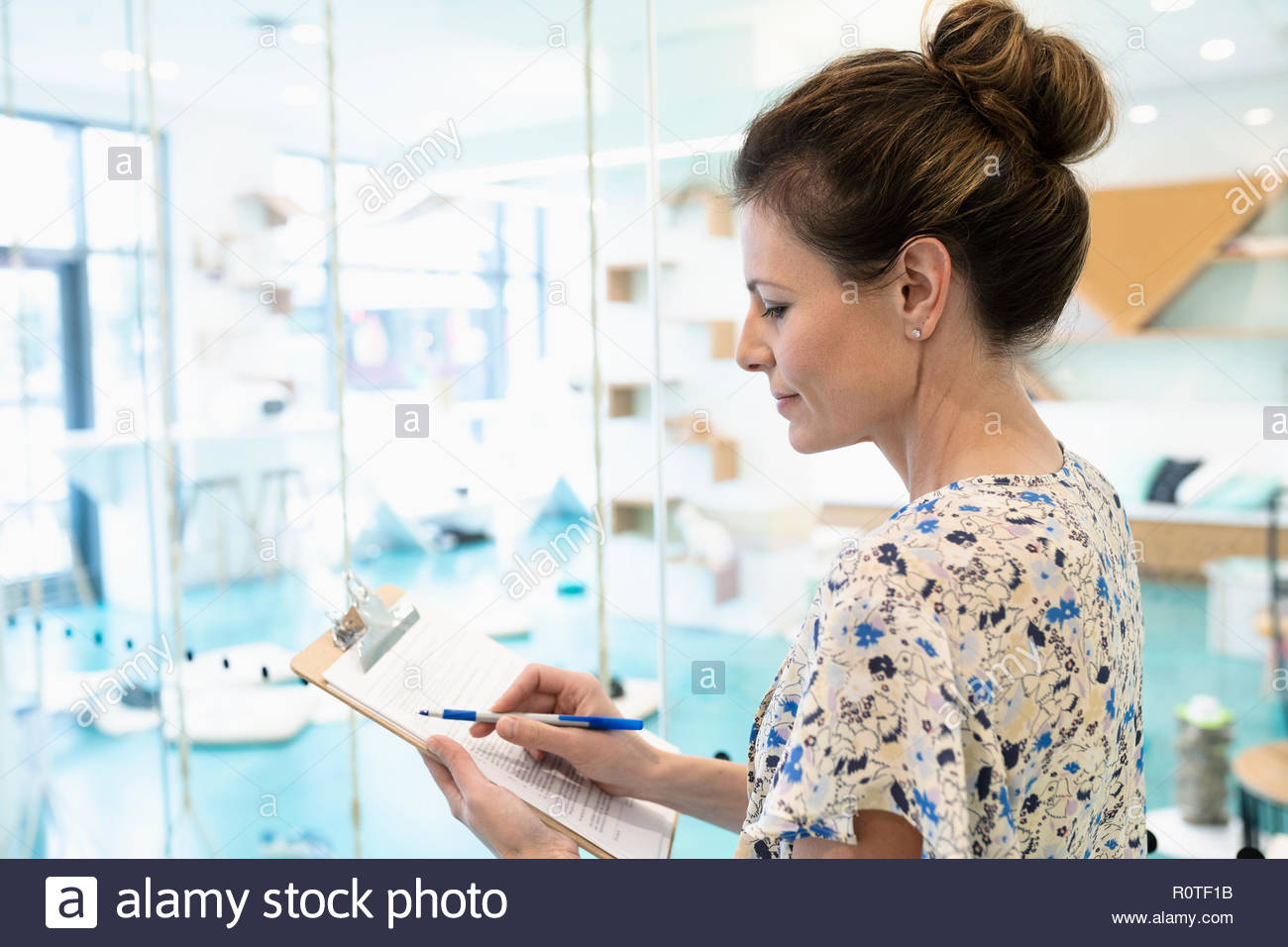 Woman filling out adoption application in cat cafe Stock Photo