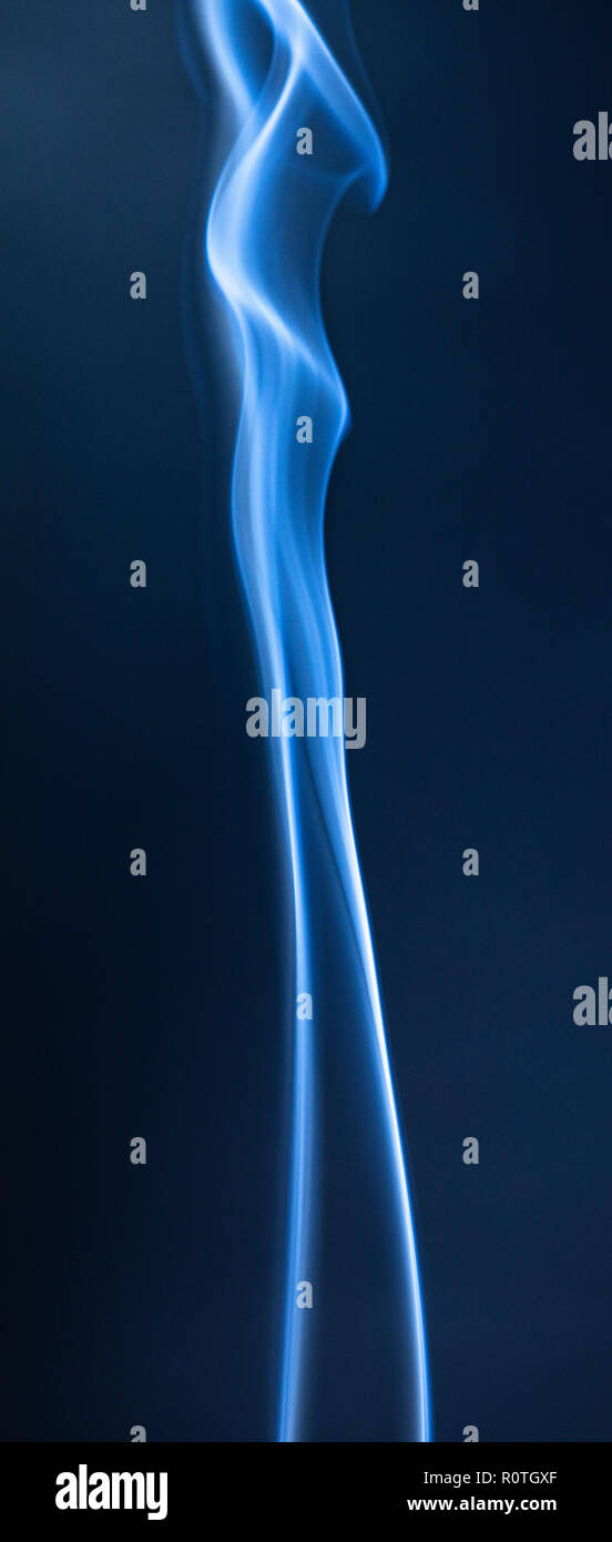 Abstract blue smoke swirls on dark background Stock Photo - Alamy