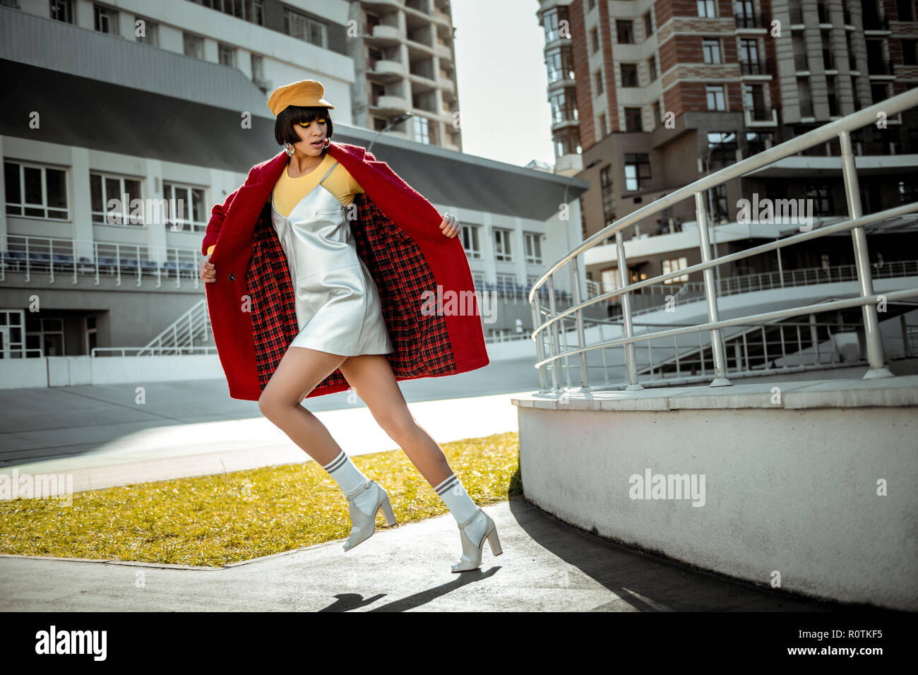 Beautiful dark-haired woman unrealistically stepping with her white shoes Stock Photo
