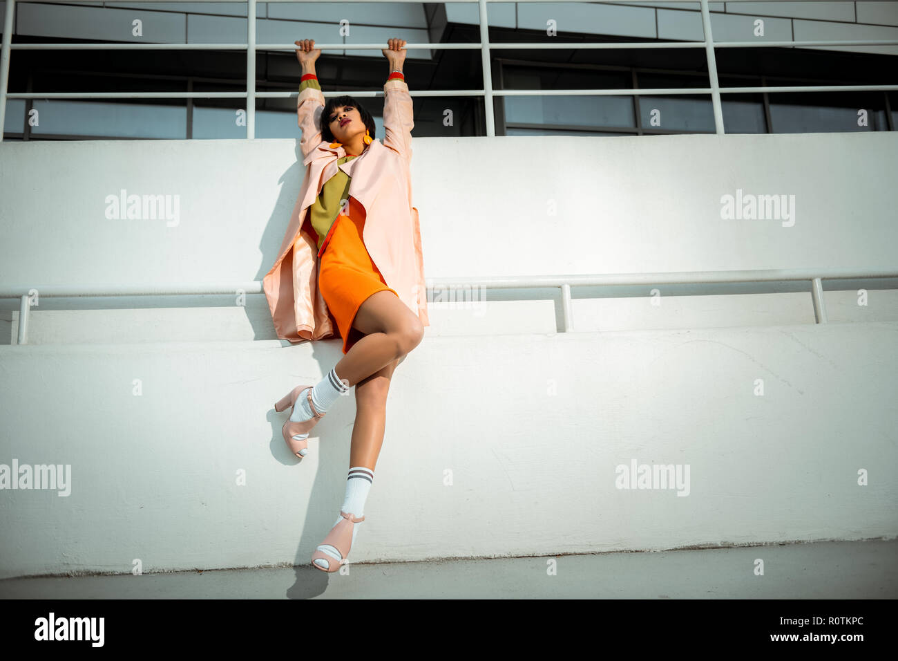 Beautiful atypical girlfriend hanging on the white wall Stock Photo Alamy