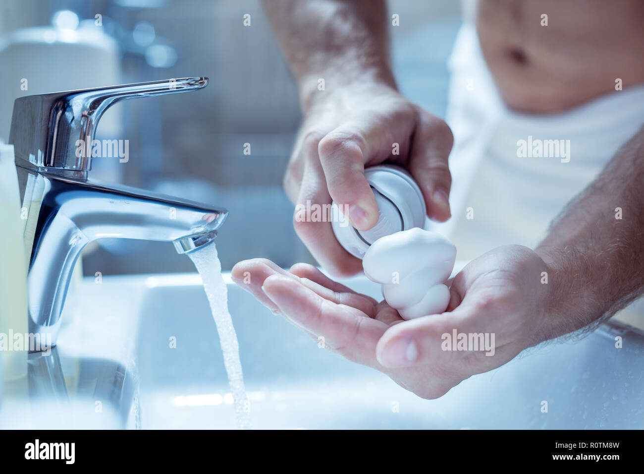 Top view of male hands using shaving foam after taking shower Stock Photo
