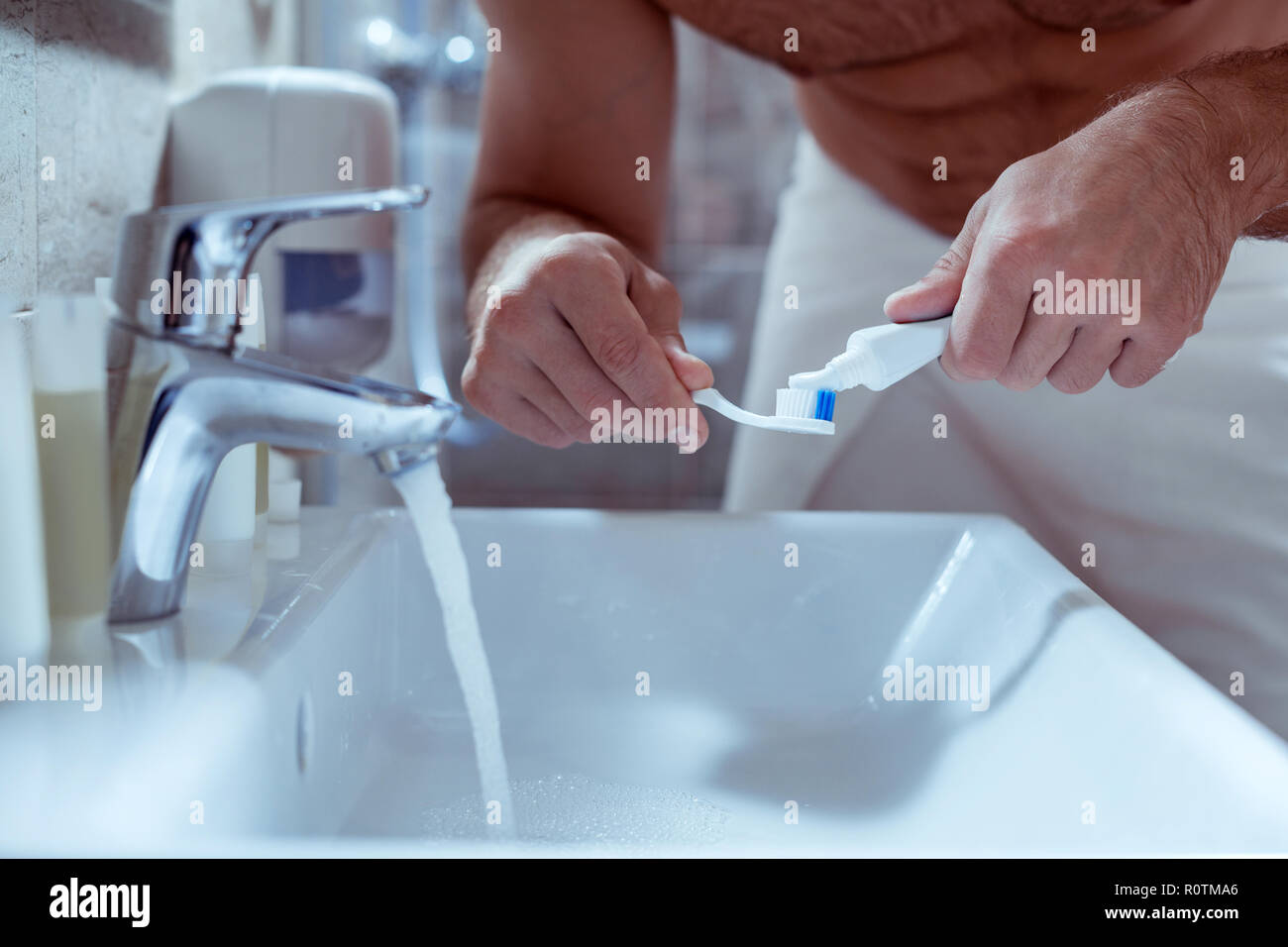 Man putting toothpaste on toothbrush hi-res stock photography and ...