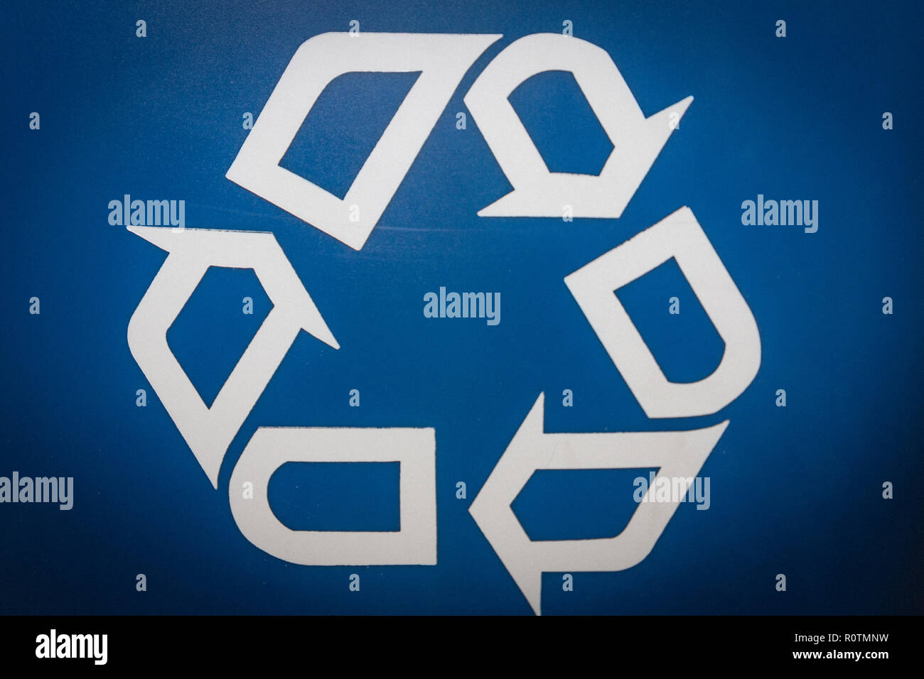 Recycling logo printed on a blue recycling bin Stock Photo