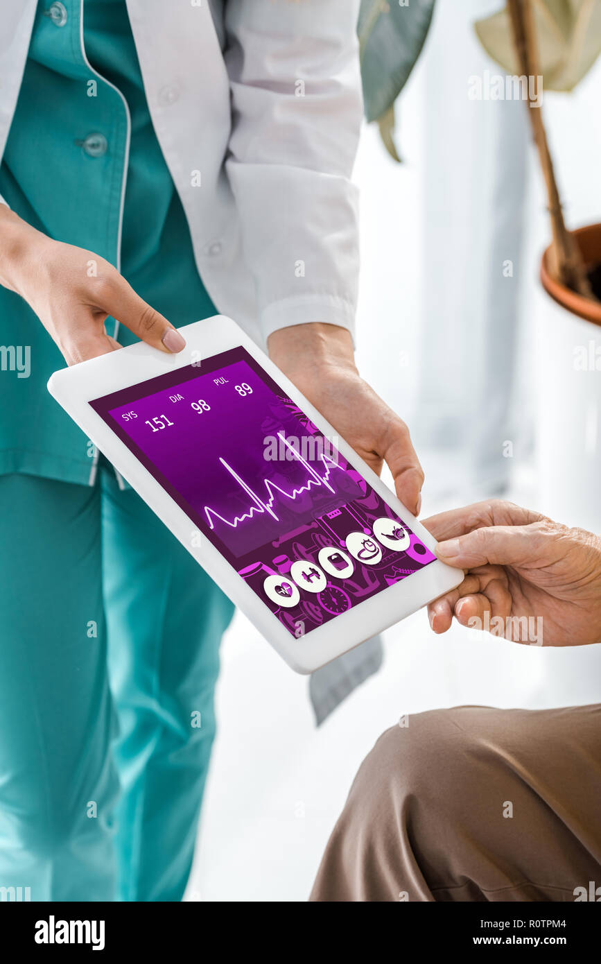 close up on doctor and patient hands holding digital tablet with ...