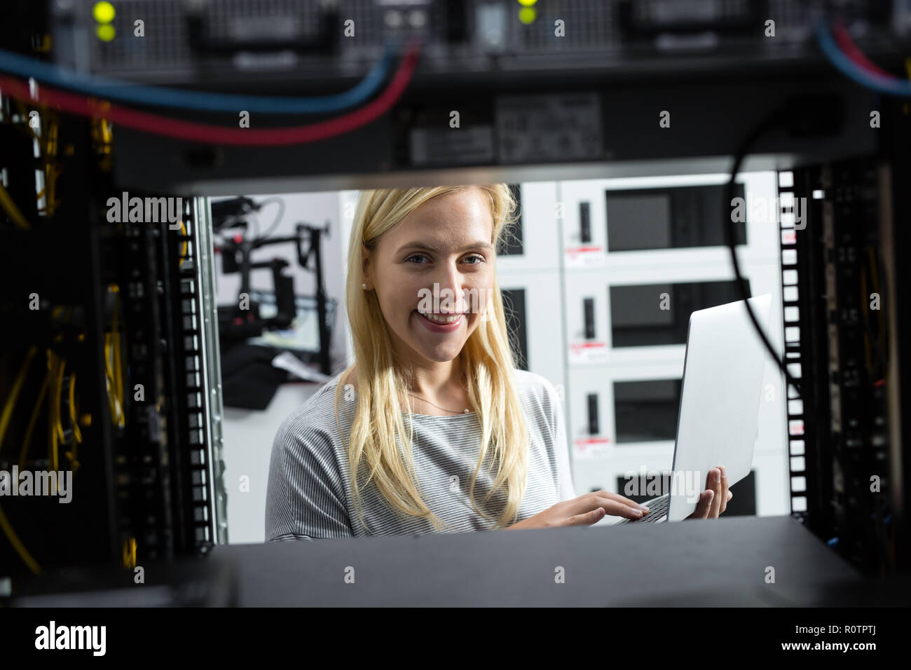 Technician examining server in server room Stock Photo