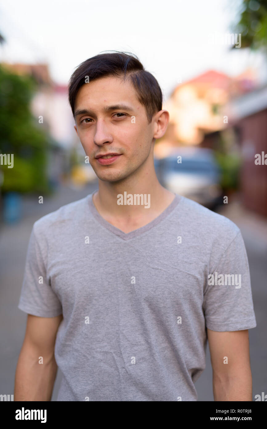 Portrait of young handsome man outdoors looking at camera Stock Photo