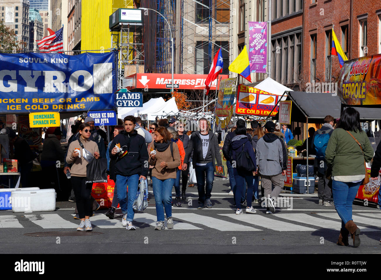 A crowd of people enjoying the afternoon at a generic street fair in Manhattan, New York, NY Stock Photo