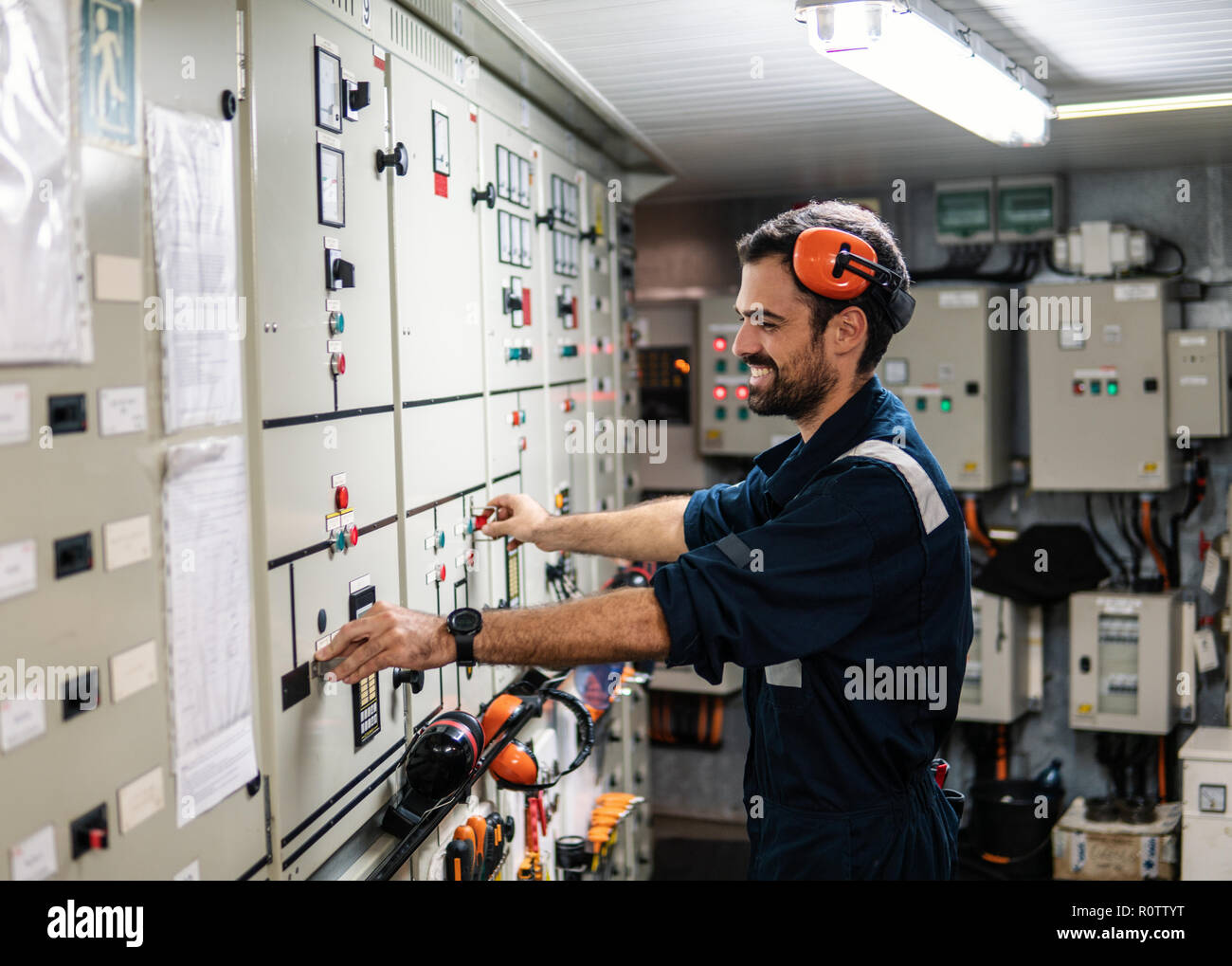 Marine engineer officer working in engine room Stock Photo - Alamy