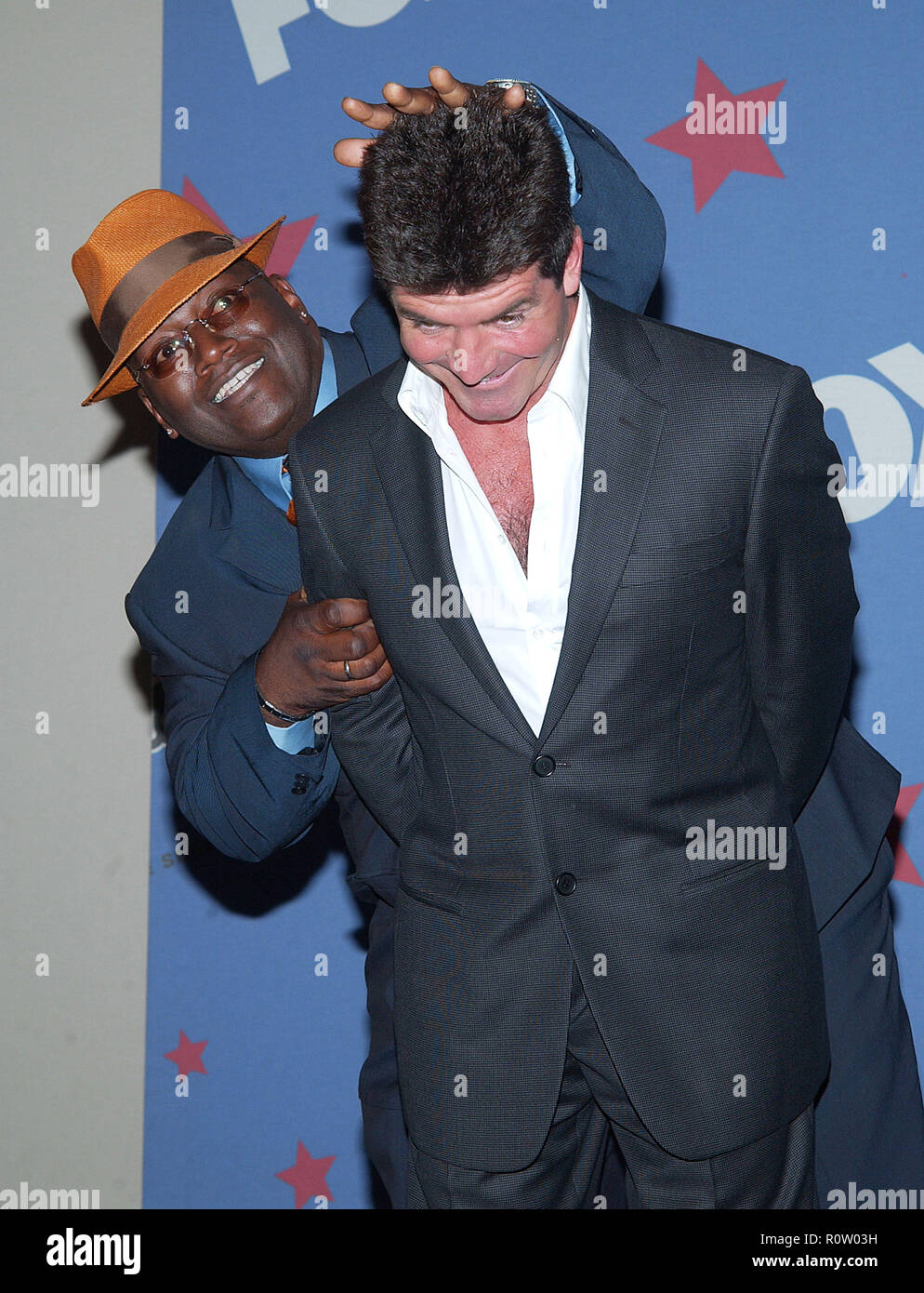Simon Cowell posing with Randy Jackson backstage at the American Idol