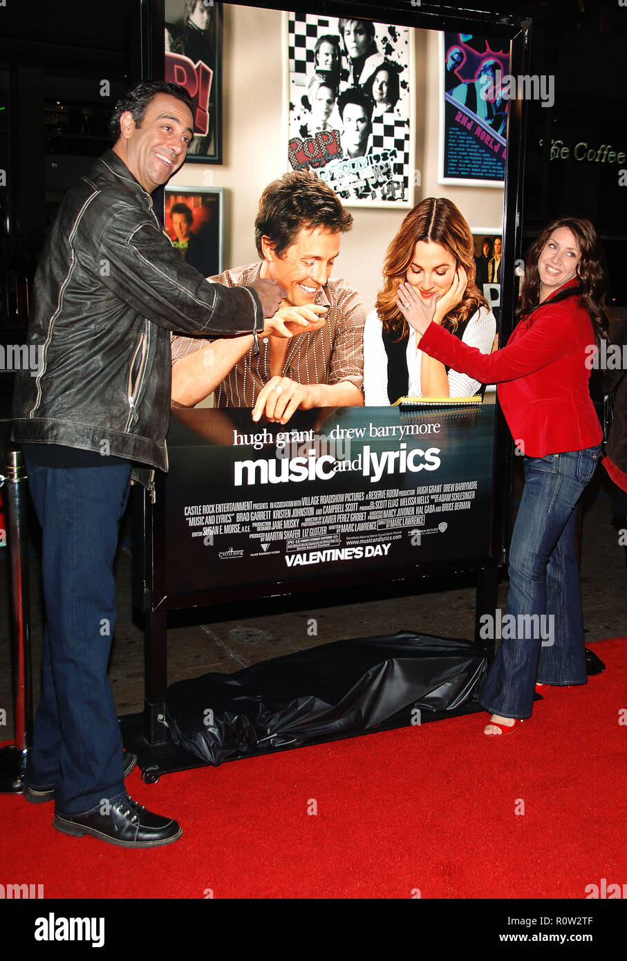 Brad Garrett and Joely Fisher arriving at the Music And Lyrics Premiere at the Chinese Theatre in Los Angeles.   full length smile fun          -      Stock Photo