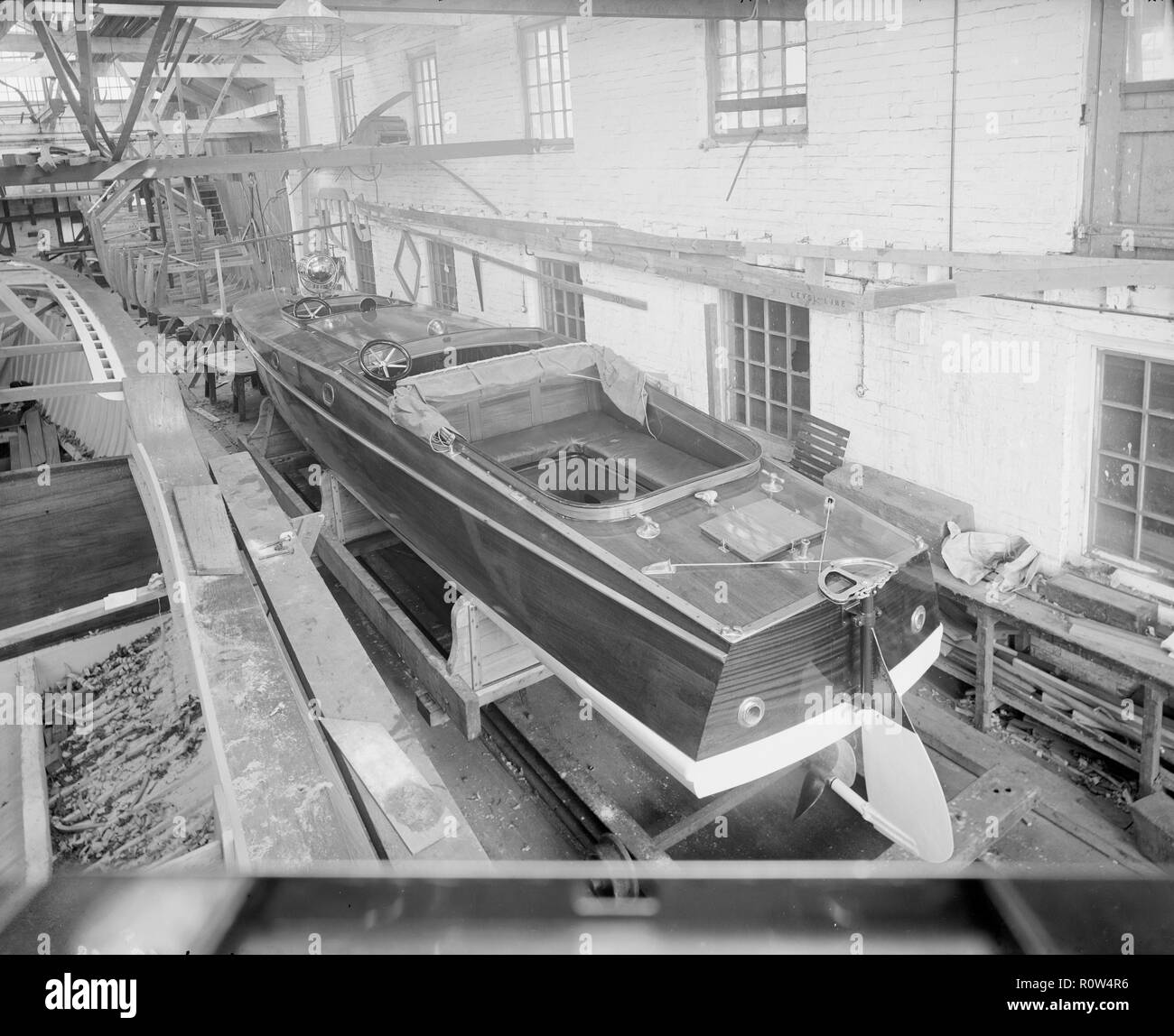 Motor launch in boatyard shed, 1913. Creator: Kirk & Sons of Cowes. Stock Photo
