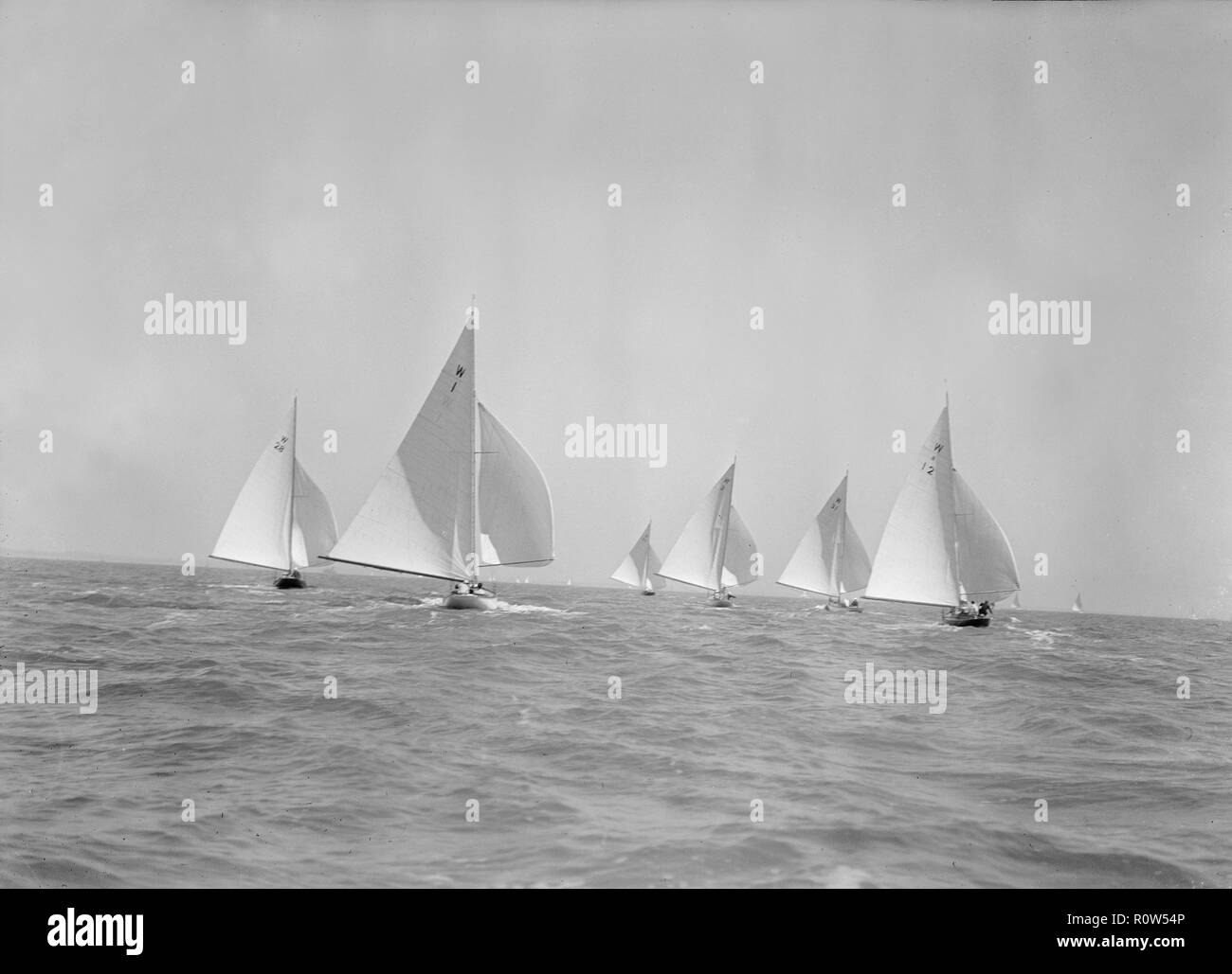 Stern view of W Class boats racing downwind, 1933. Creator: Kirk & Sons of Cowes. Stock Photo