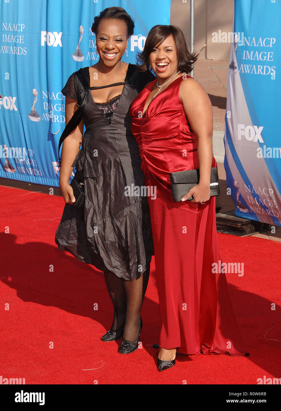 Marianne Jean-Bathiste and Chandra Wilson  at the 38th NAACP Awards 2007 at the Shrine Auditorium In Los Angeles.  full length eye contact smile red d Stock Photo