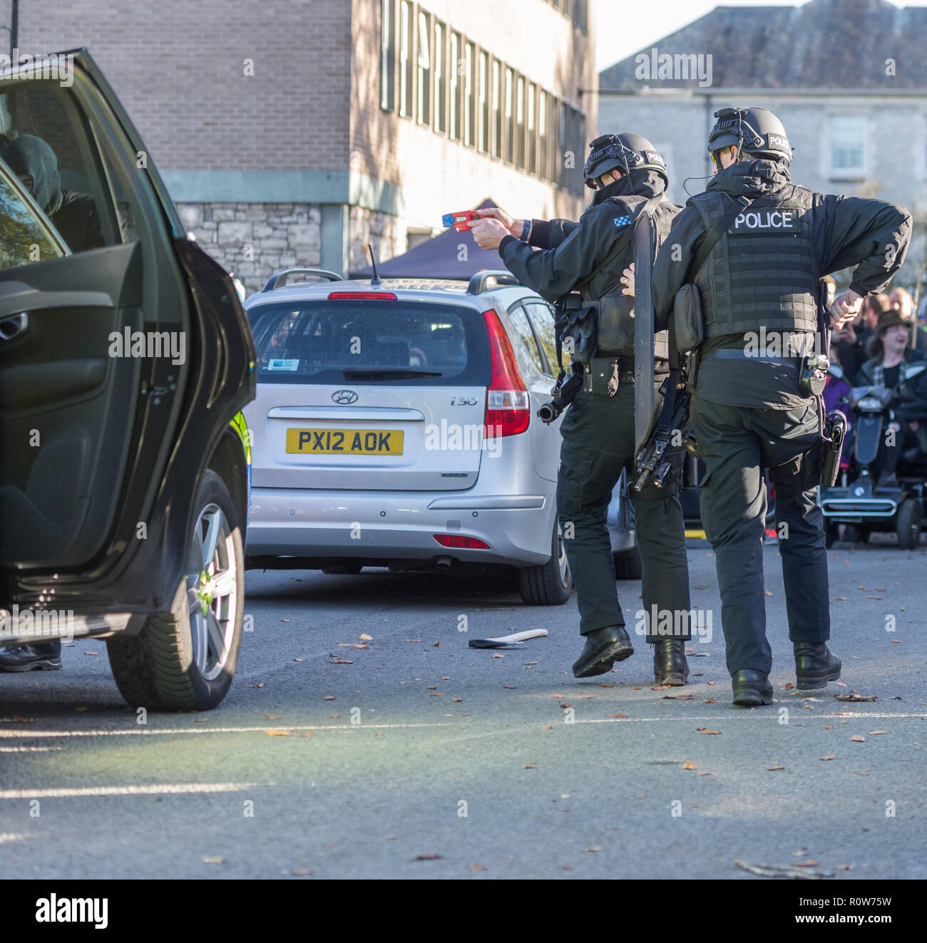 Armed Firearms Police officers demonstrating a vehicle stop and arrest of a suspected armed criminal/terrorist at a police open day Stock Photo