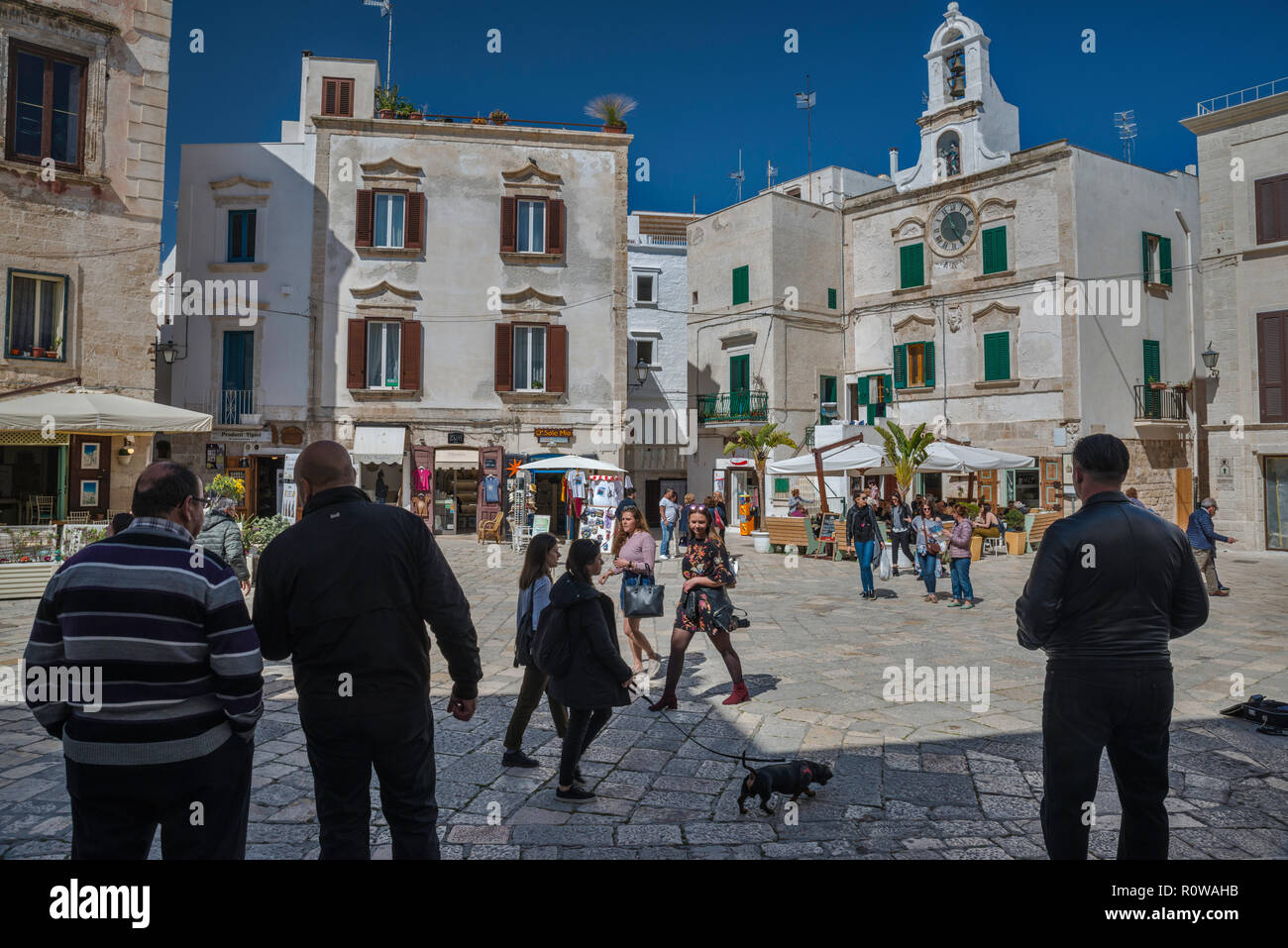 Local people and tourists at Piazza dell'Orologio in Polignano a Mare,  Apulia, Italy Stock Photo - Alamy