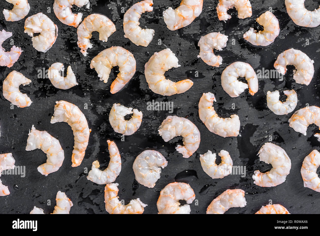 Group of shrimps on black background, flat lay overhead Stock Photo Alamy