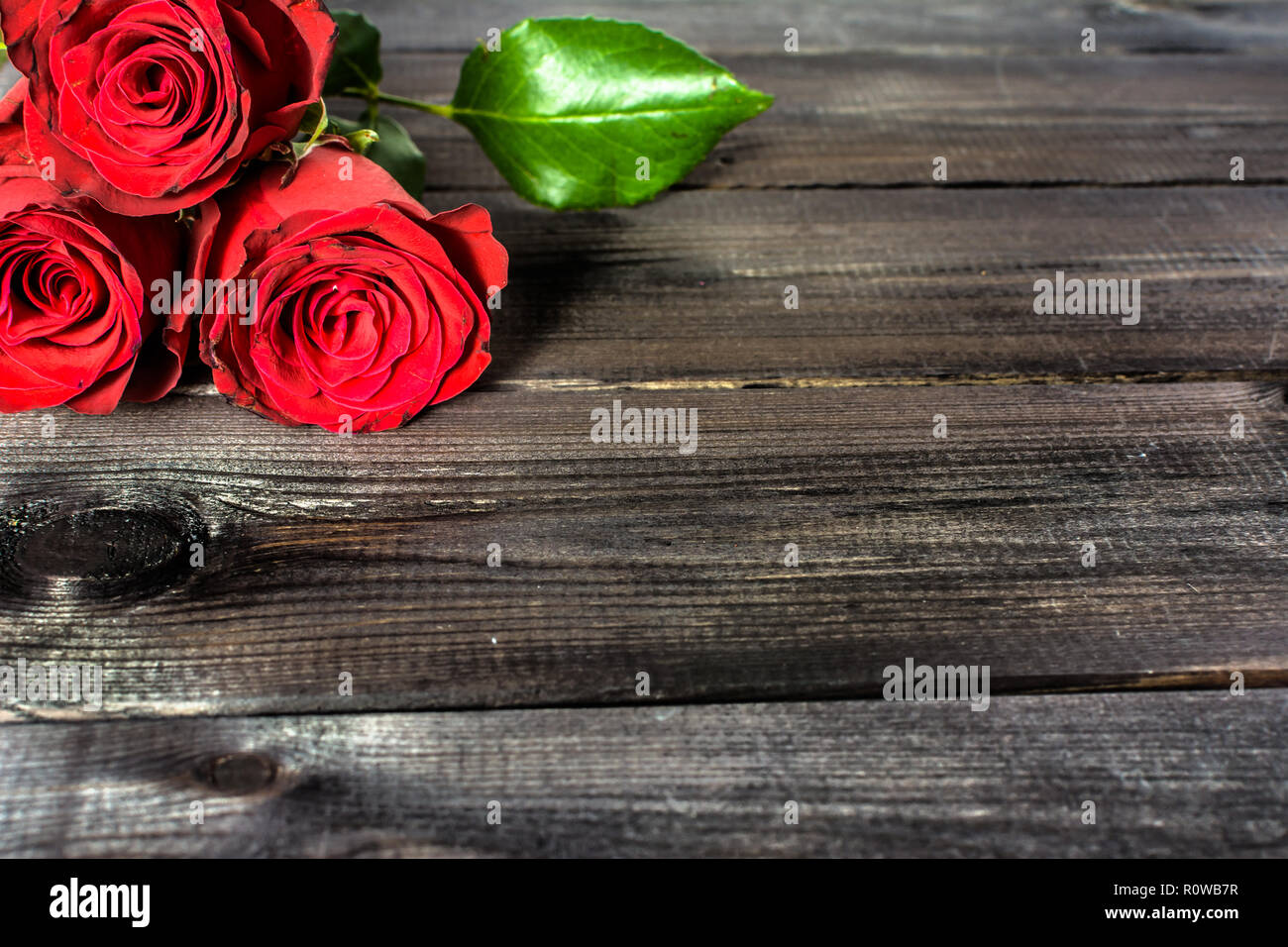Red roses on wooden background, valentines card Stock Photo - Alamy
