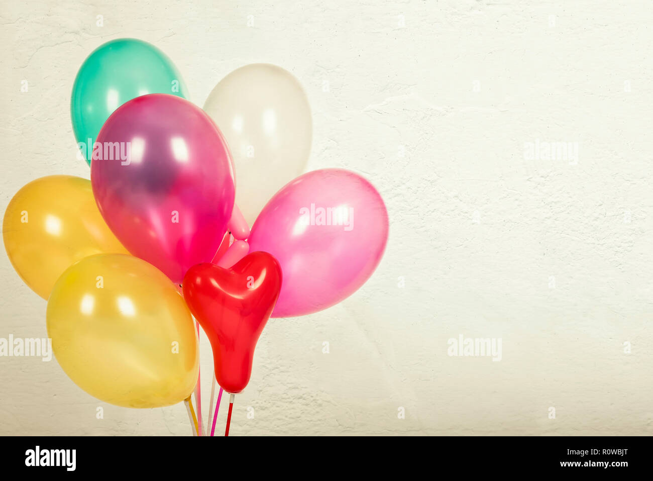 Colorful balloons with a retro vintage filter effect. The concept of happy birthday in summer and wedding honeymoon party, anniversary and holiday bac Stock Photo