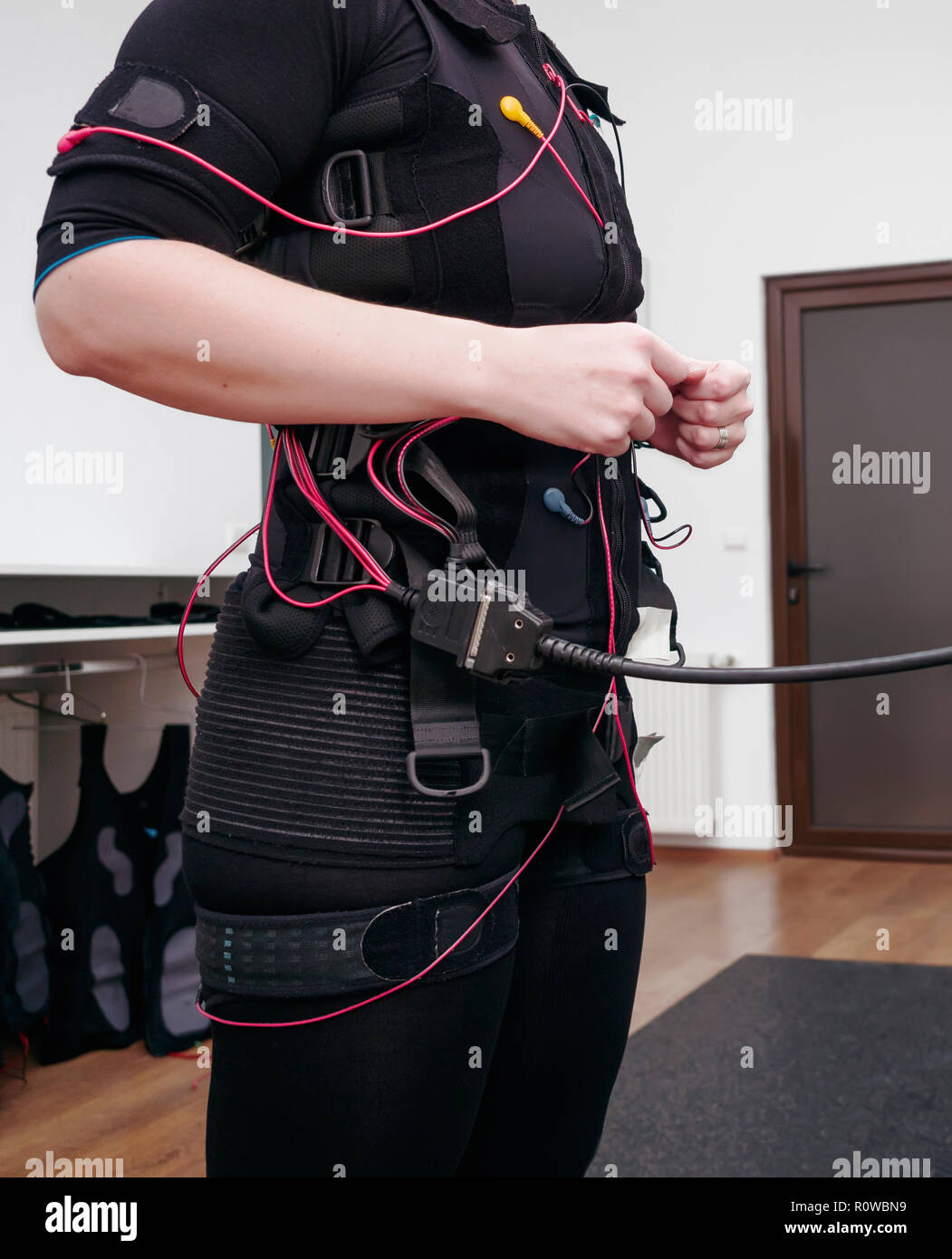 Woman in electro muscular stimulation suit ready for exercises Stock Photo