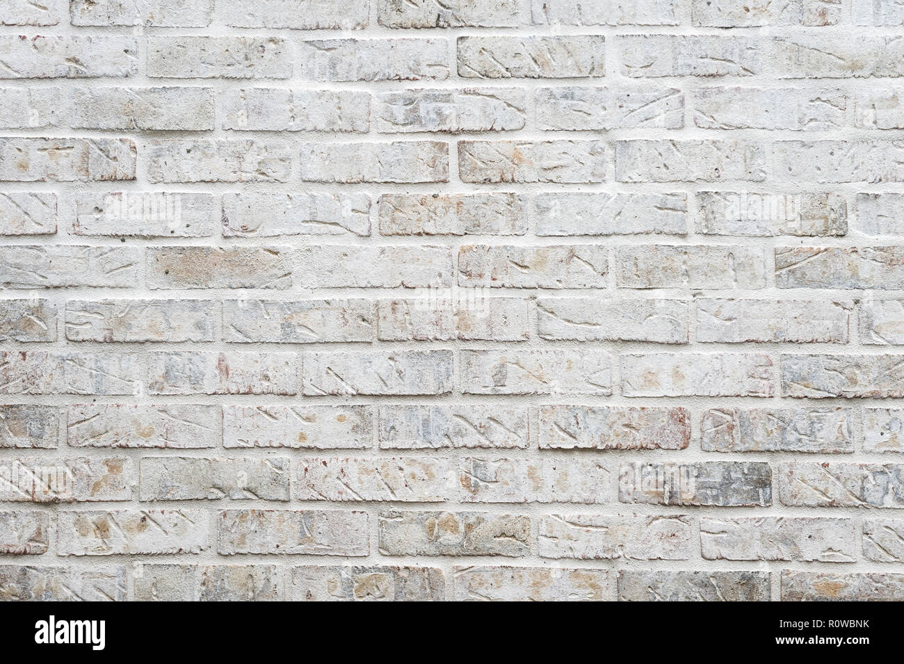 White painted brick wall full frame background with gritty textured ...