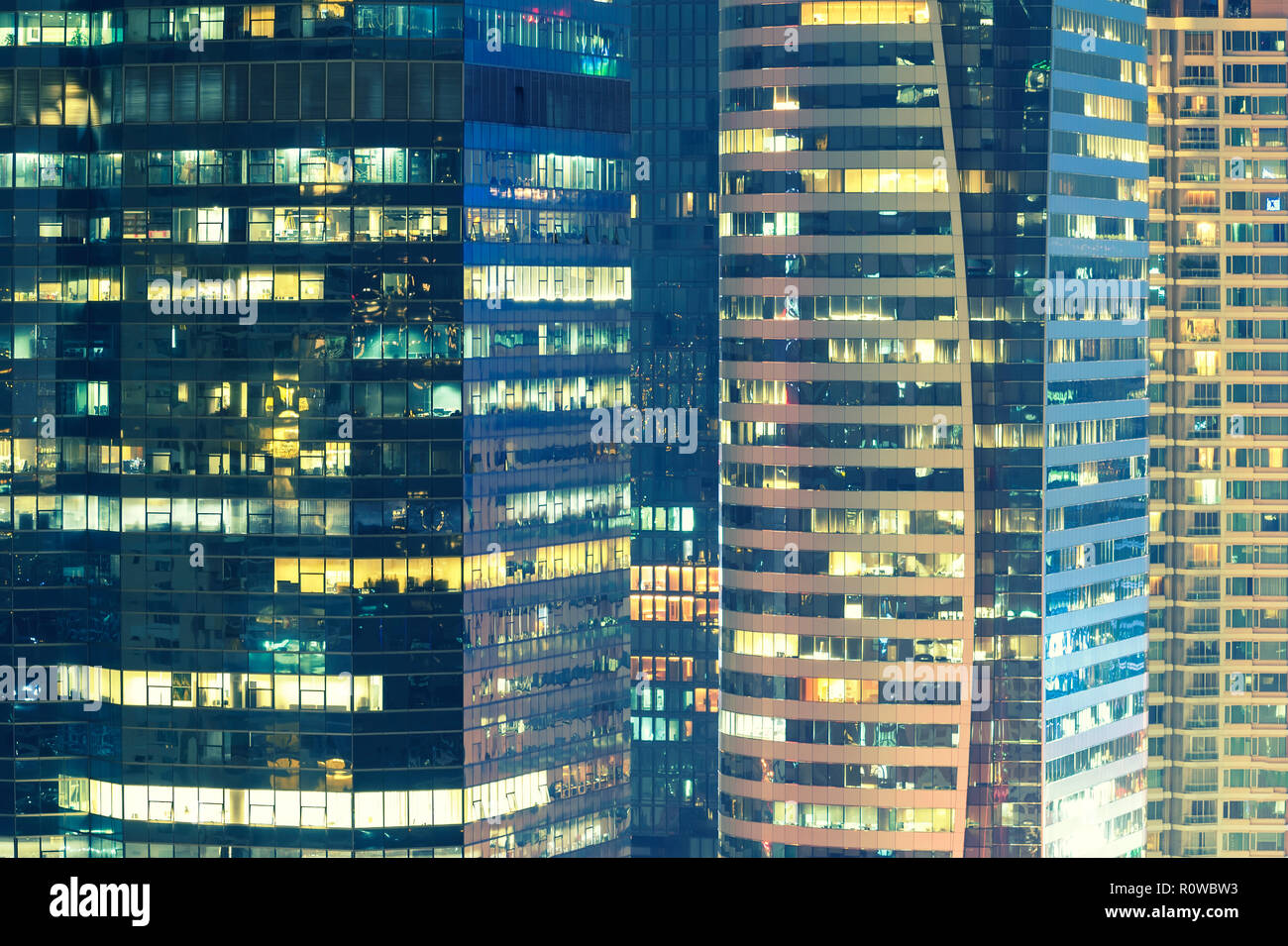 Abstract background from closeup of high modern building in business center at night. Business and finace background. Stock Photo
