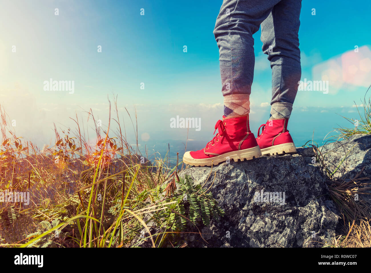 Close up of red shoes of traveller standing on mountain peak with blue sky  at sunset. Freedom lifestyle. Good life and healthy concept. Picture for ad  Stock Photo - Alamy