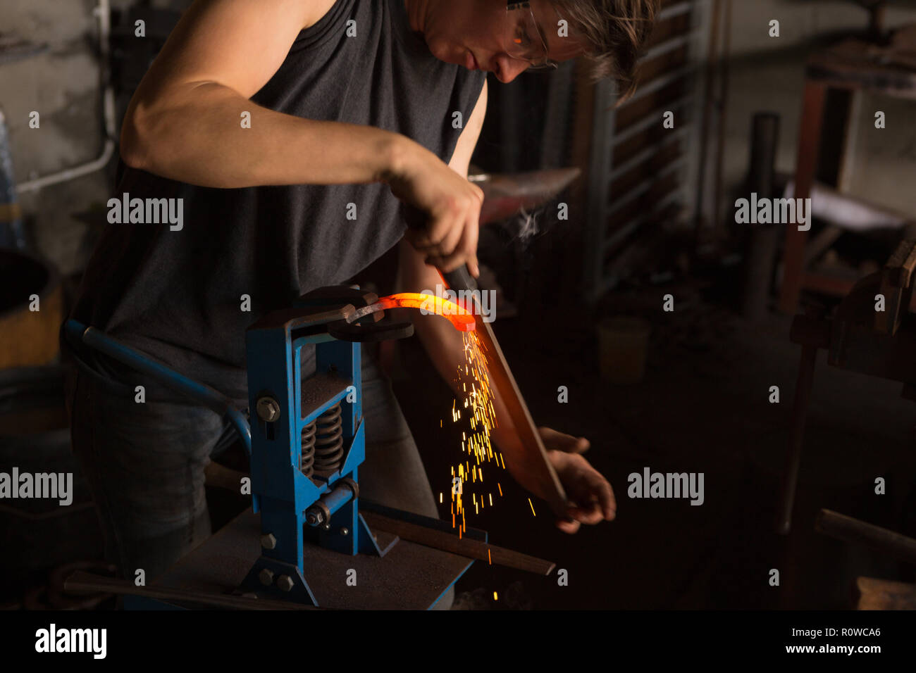 Female metalsmith shaping horseshoe in factory Stock Photo Alamy