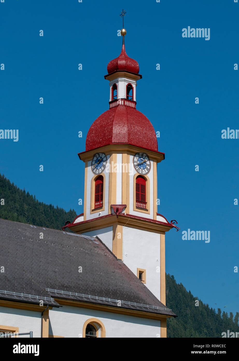Neustift im Stubaital, the parish church of St. George in the town centre with a blue sky background, Tyrol, Austria Stock Photo