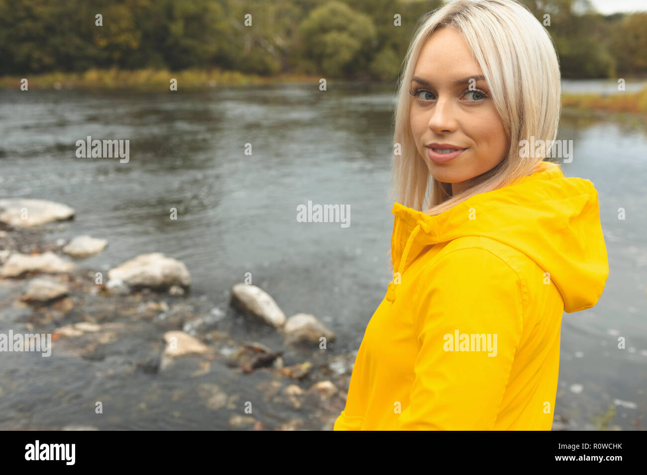 Woman standing near river Stock Photo - Alamy