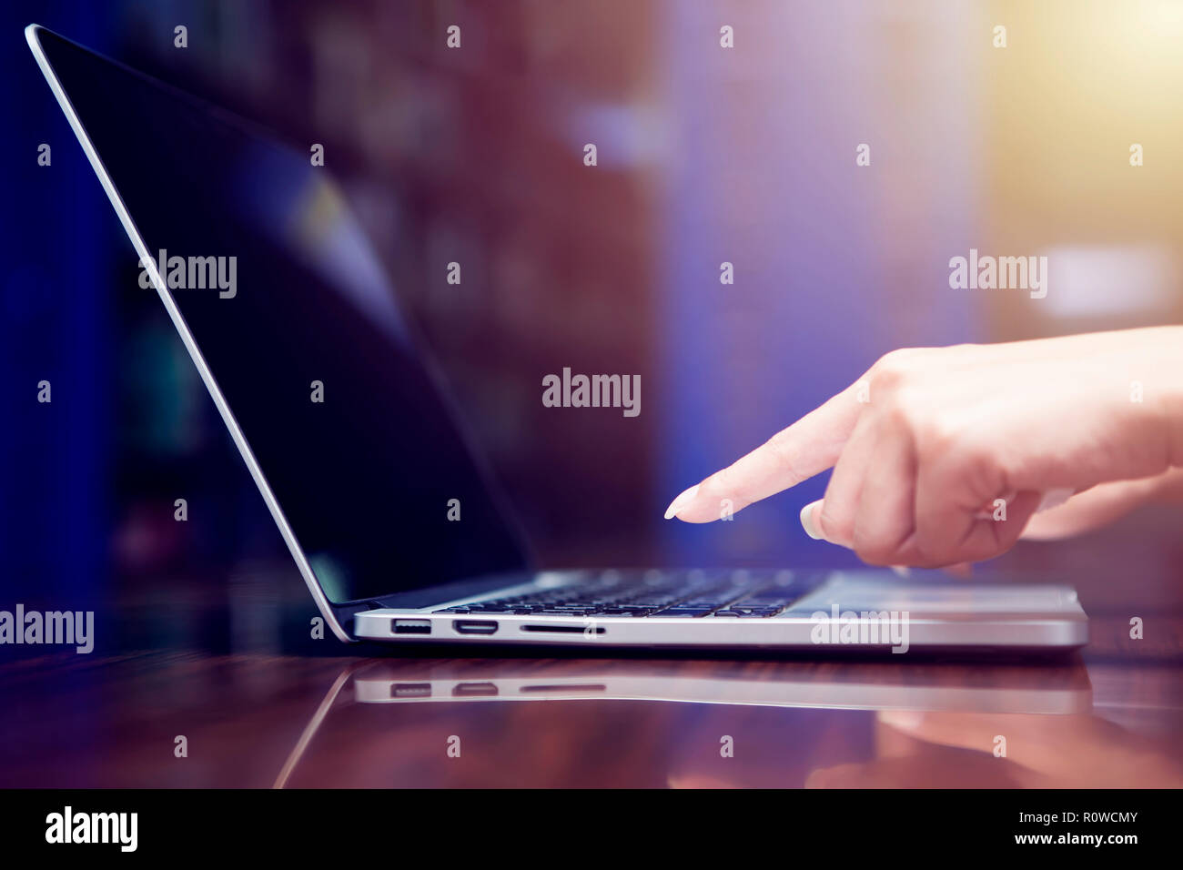 Business and technology concept. Closeup hand touching a button on keyboard with free copy space. E-commerce or online business. Network connection. Stock Photo