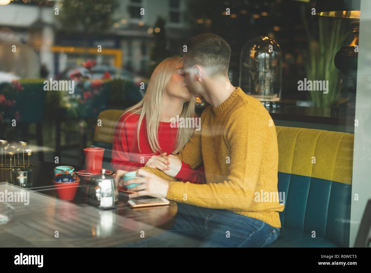Couple kissing in cafeteria Stock Photo