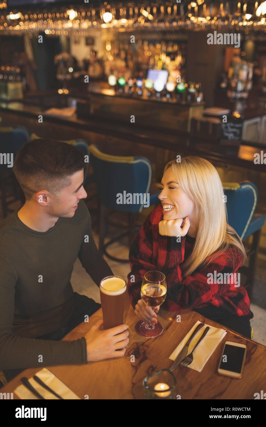 Couple having drinks in restaurant Stock Photo