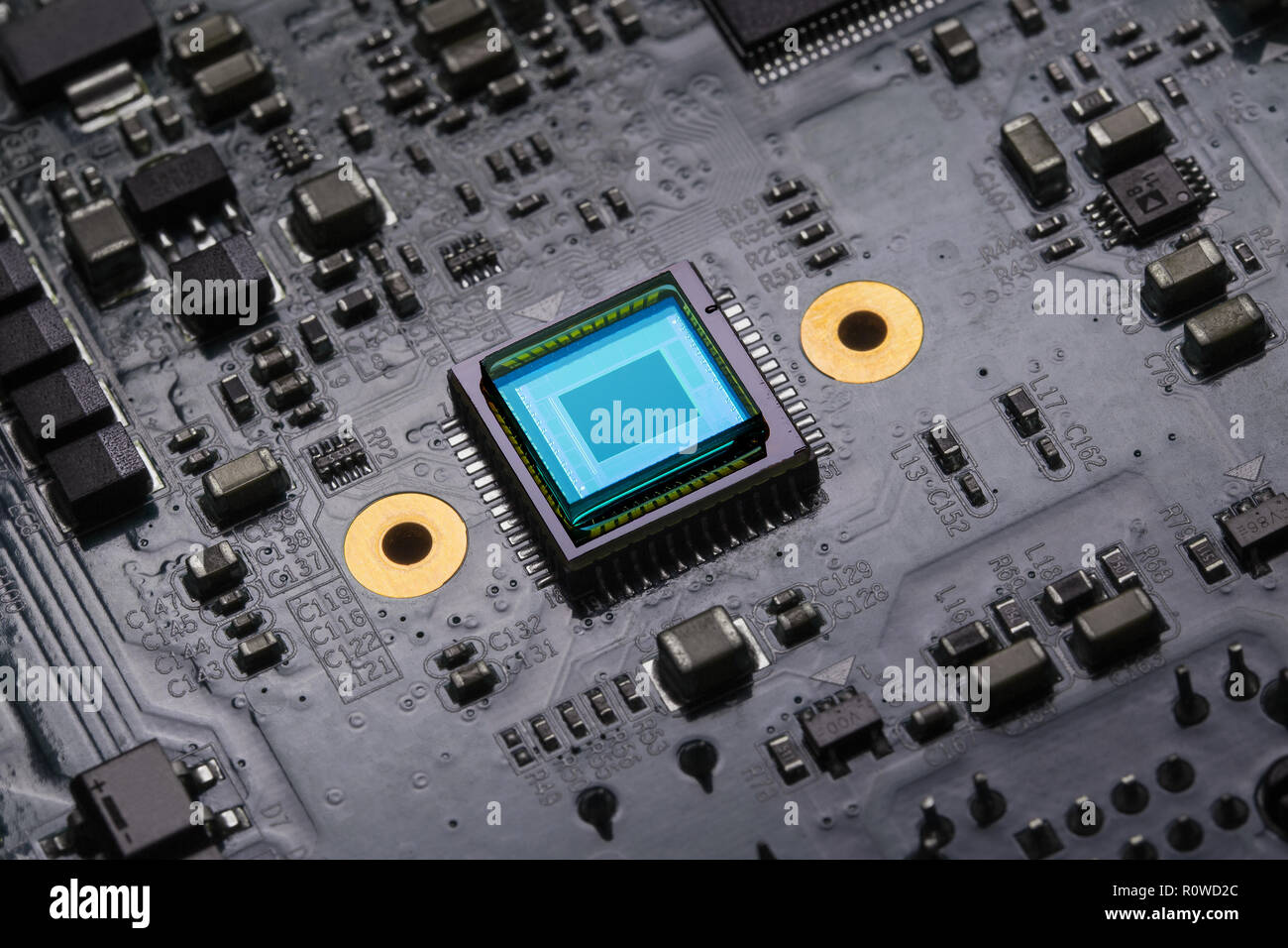 Photosensitive sensor on a printed circuit board closeup with a blue glow Stock Photo